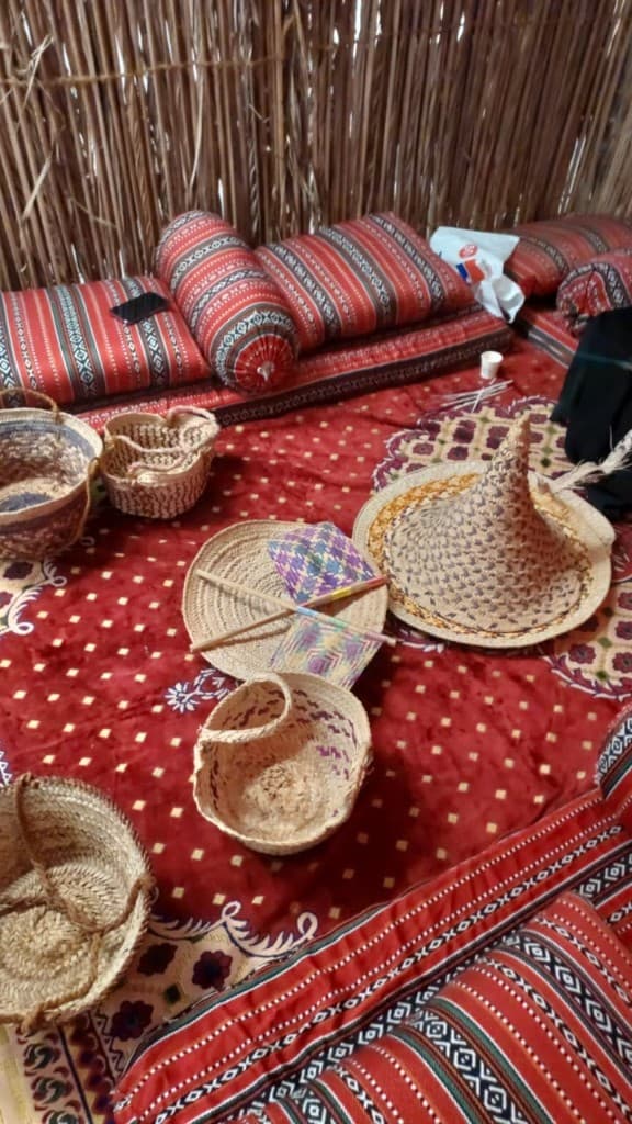 Barasti-walled majlis with Sadu cushions and woven khous baskets in Abu Dhabi