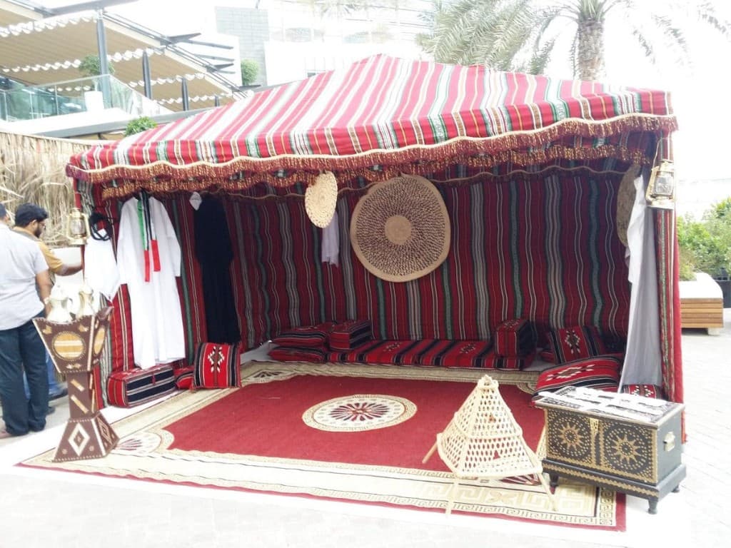 Sadu heritage tent with mandoos chest, dallah stand and majlis cushions in Abu Dhabi