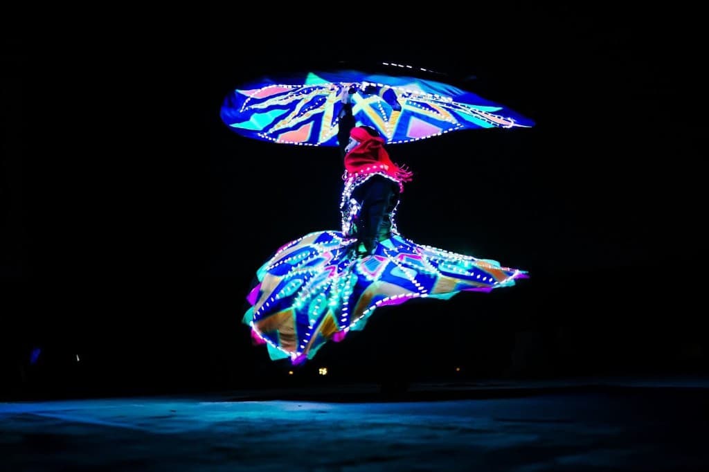Tanoura dancer in an LED-lit spinning costume performing at night in Abu Dhabi
