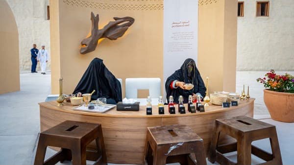 Perfumed oud demonstration counter with attar bottles and brass vessels in Abu Dhabi
